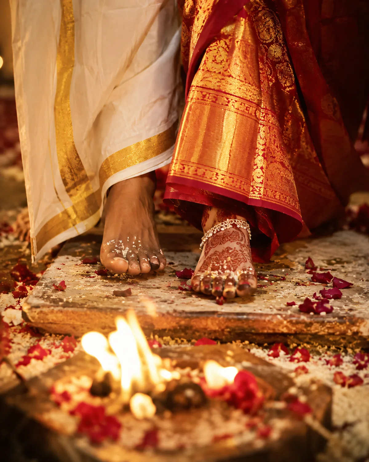 Close-up of bride and groom's feet during Saptapadi sacred fire ritual at a Hindu wedding ceremony