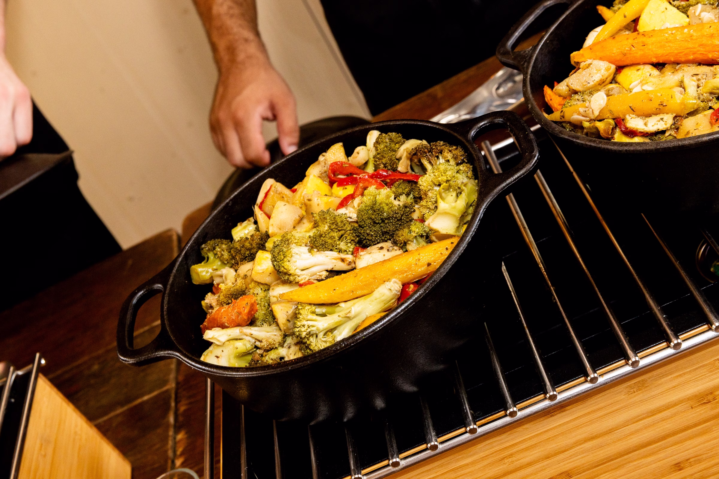 Cast iron skillets filled with roasted broccoli, carrots, and mixed vegetables served at a wedding reception at Orlando Celebration Gardens in Orlando Florida