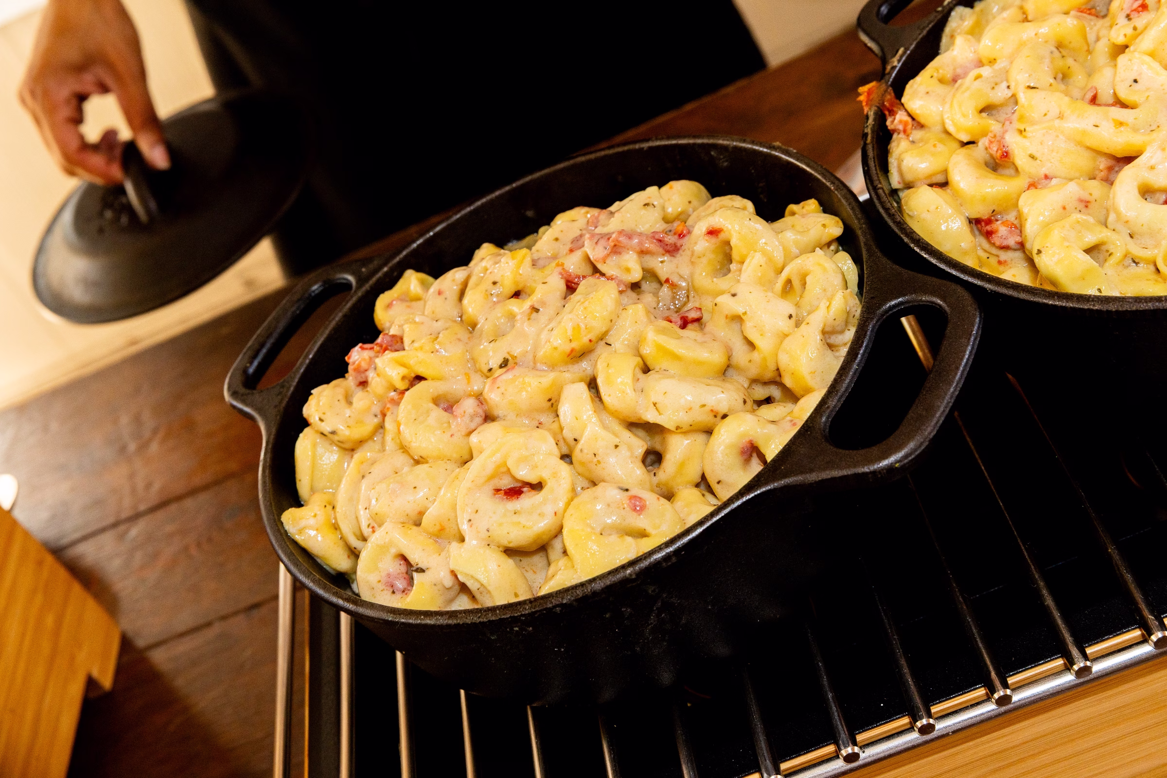 Creamy tortellini carbonara with bacon served in cast iron skillets at a wedding reception at Orlando Celebration Gardens in Orlando Florida